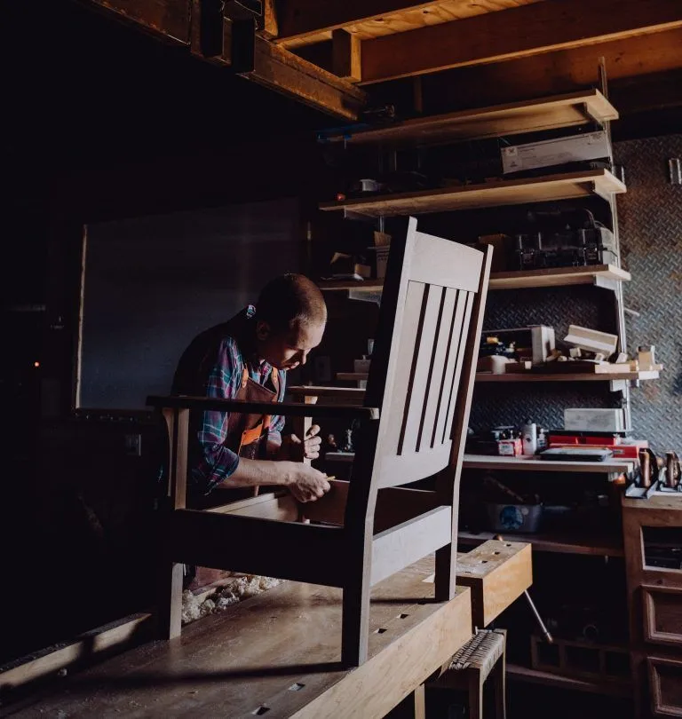 a man is building a wooden chair
